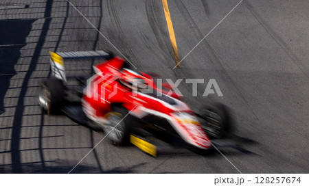 Motion blur race car racing on speed track, Motion blurred super car race on street track circuit, Automobile automotive transportation vehicle background, Race car drive on street track. 128257674