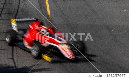 Motion blur race car racing on speed track, Motion blurred super car race on street track circuit, Automobile automotive transportation vehicle background, Race car drive on street track. 128257675