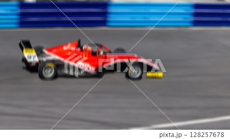 Motion blur race car racing on speed track, Motion blurred super car race on street track circuit, Automobile automotive transportation vehicle background, Race car drive on street track. 128257678