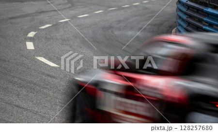 Motion blur race car racing on speed track, Motion blurred super car race on street track circuit, Automobile automotive transportation vehicle background, Race car drive on street track. Motion blur race car racing on speed track, Motion blurred super car race on street track circuit, Automobile automotive transportation vehicle background, Race car drive on street track. 128257680