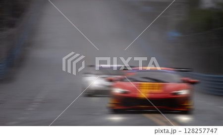 Motion blur race car racing on speed track, Motion blurred super car race on street track circuit, Automobile automotive transportation vehicle background. Motion blur race car racing on speed track, Motion blurred super car race on street track circuit, Automobile automotive transportation vehicle background. 128257747