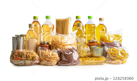 Foodstuff for donation, storage and delivery. Various food, pasta, cooking oil and canned food in cardboard box. 128258360