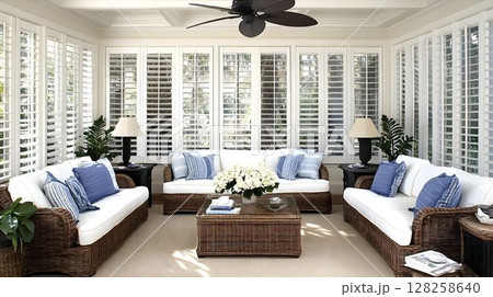 Bright sunroom interior with white sofas and wicker furniture Bright sunroom interior with white sofas and wicker furniture 128258640