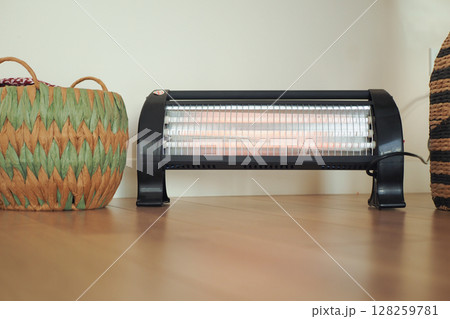 Modern electric infrared heater in living room, closeup 128259781