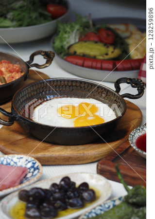 Breakfast with fresh eggs in a traditional pan 128259896
