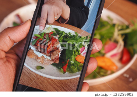 Mobile Photograph of a Delicious Meal on a Wooden Dining Table 128259902