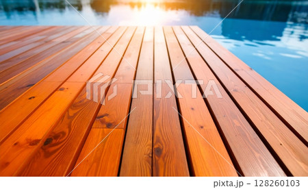 Old wooden pier stretching over the blue sea, its textured planks reflecting the summer sky Old wooden pier stretching over the blue sea, its textured planks reflecting the summer sky 128260103