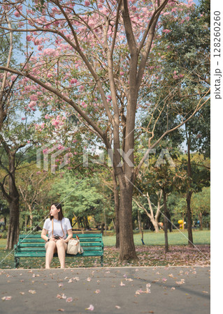 asian woman solo traveler relax and enjoy to see pink cherry blossom blooming from springtime road trip asian woman solo traveler relax and enjoy to see pink cherry blossom blooming from springtime road trip 128260260