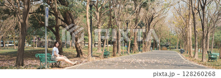 asian woman solo traveler relax and enjoy to see pink cherry blossom blooming from springtime road trip 128260268