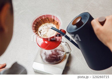 Person Pouring Drink Into Pitcher Person Pouring Drink Into Pitcher 128260715