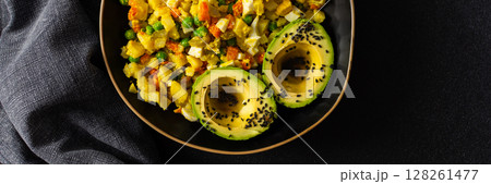A colorful salad combines boiled egg, tender chicken breast, diced potatoes, vibrant carrots, and fresh green peas, topped with creamy avocado and sesame seeds, all drizzled with olive oil, banner 128261477