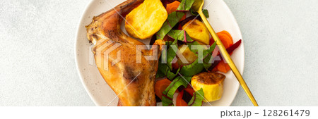 This gourmet dinner features succulent baked rabbit, golden roasted potatoes, and a fresh carrot salad, offering a nutritious, hearty, and savory option for a memorable meal, banner 128261479