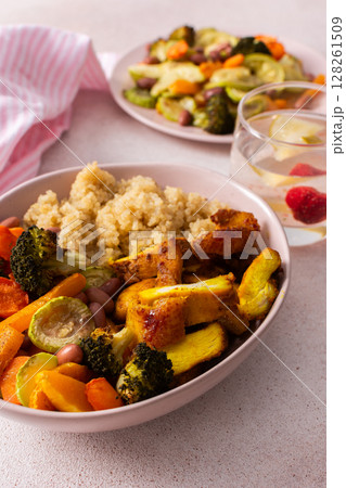 A well-balanced breakfast spread showcasing quinoa, baked sweet potato with carrots, zucchini, broccoli, beans, and baked chicken breast seasoned with turmeric A well-balanced breakfast spread showcasing quinoa, baked sweet potato with carrots, zucchini, broccoli, beans, and baked chicken breast seasoned with turmeric 128261509