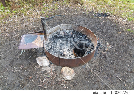 A steel ringed fire pit in a large family campground in the mountains A steel ringed fire pit in a large family campground in the mountains 128262262