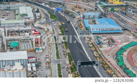July 6 2025 Modern Road Construction Site with Heavy Machinery and Infrastructure Development 128263086