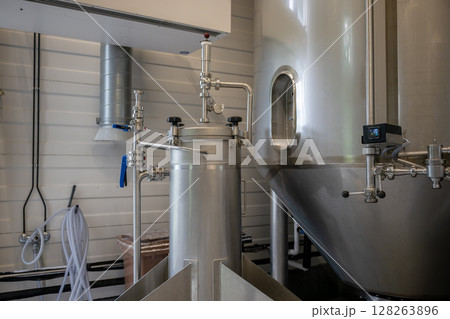 Modern stainless steel brewing equipment in craft brewery for beer production 128263896