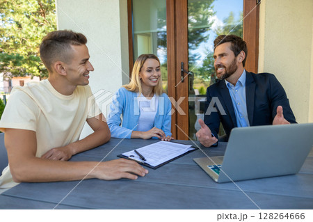 Real estate agent discussing deal details with the clients Real estate agent discussing deal details with the clients 128264666