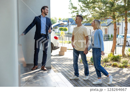 Male real estate agent presenting a new house to the clients Male real estate agent presenting a new house to the clients 128264667