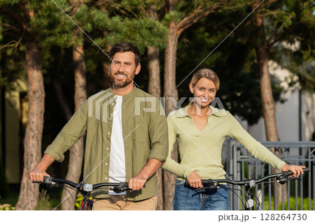 Man and woman with bikes outside home ready for outdoor ride Man and woman with bikes outside home ready for outdoor ride 128264730