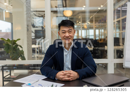 Asian young businessman working in his office and looking busy Asian young businessman working in his office and looking busy 128265305