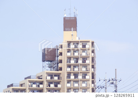 屋上に残された広告看板の跡とアンテナ群が見える都市の建物 128265911