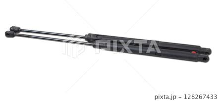 A pair of black metal hood shock absorbers with chrome elements - detail of a car mechanism on a white isolated background. Spare parts for body repair 128267433