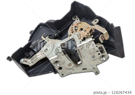 Detail of a car spare part made of black plastic and metal - door lock separately isolated on a white background. Repair in a car workshop, equipment for sale Detail of a car spare part made of black plastic and metal - door lock separately isolated on a white background. Repair in a car workshop, equipment for sale 128267434