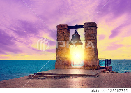 Old bell at sunset in the ancient city of Chersonesus, Sevastopol, Crimea Old bell at sunset in the ancient city of Chersonesus, Sevastopol, Crimea 128267755