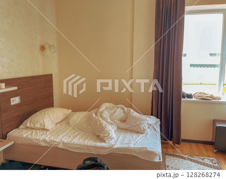 Unmade Bed in Minimalist Room 128268274