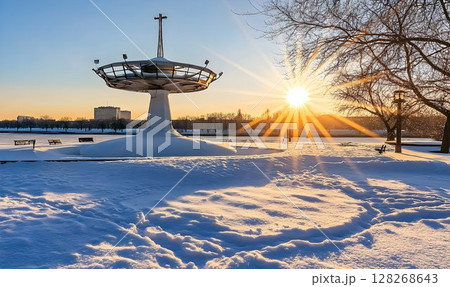 City park under winter sunrise with architectural landmark and snowscape 128268643