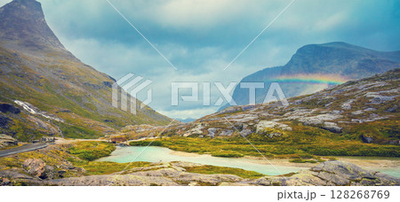 Mountain landscape. Rocky shore of mountain lake in rainy autumn morning. Beautiful nature Norway. 128268769