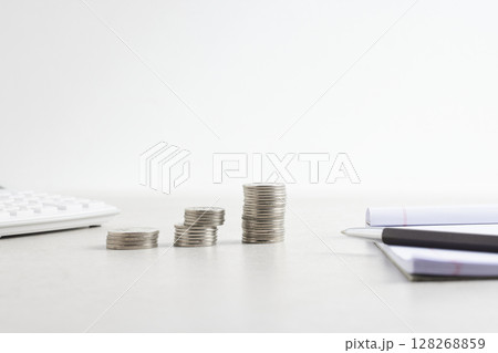 Coins and objects on a table with a financial and economic concept. 128268859