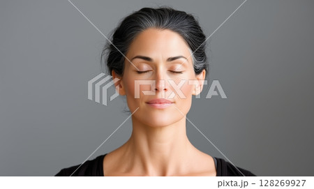 Yoga and meditation class indoor, Calm woman with closed eyes, exuding tranquility and serenity. 128269927