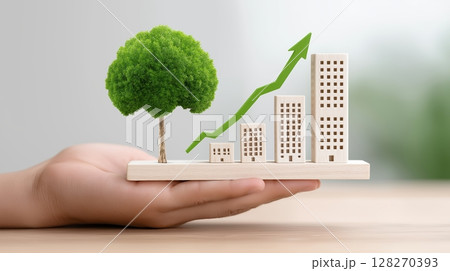 Green Sustainable Technology Innovation concept, Hand holding a model of buildings and a tree with a growth graph. 128270393