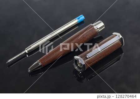Branded pen with cufflinks and business card holder in a box. Gift set. Office interior. 128270464