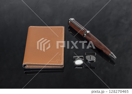 Branded pen with cufflinks and business card holder in a box. Gift set. Office interior. Branded pen with cufflinks and business card holder in a box. Gift set. Office interior. 128270465