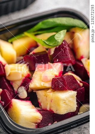 Beetroot and pineapple salad in black container 128272293