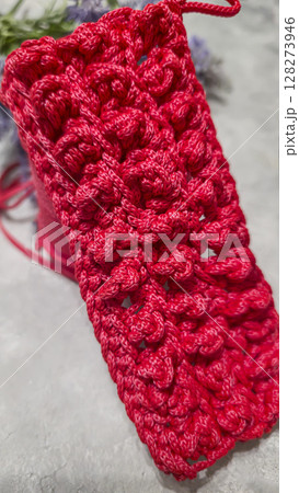 Pattern for knitting a bag. Crocheted from polyester cord. On a gray background Pattern for knitting a bag. Crocheted from polyester cord. On a gray background 128273946