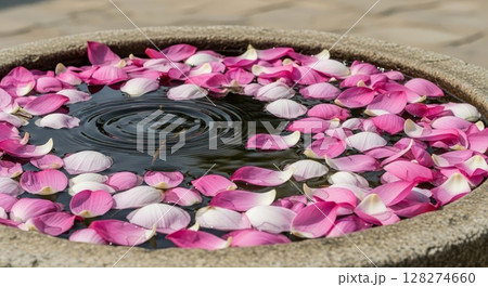 Pink Lotus Petals Floating in Circular Water Bowl Zen Meditation Spa Concept 128274660