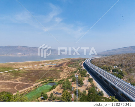 Drone shot aerial view landscape of the M6 motorway Expressway Nakhon Ratchasima Province - Bang Pa-in. Lam Ta Khong River and Mountain. Drone shot of scenic landscape rural place traffic. Nakhon Drone shot aerial view landscape of the M6 motorway Expressway Nakhon Ratchasima Province - Bang Pa-in. Lam Ta Khong River and Mountain. Drone shot of scenic landscape rural place traffic. Nakhon 128275343
