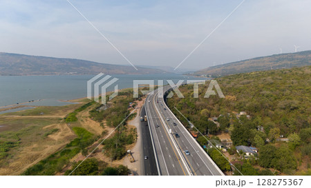 The M6  motorway Expressway Nakhon Ratchasima Province - Bang Pa-in. Lam Ta Khong River and Mountain. Drone shot of scenic landscape rural place traffic. Nakhon Ratchasima Thailand. Motorway Korat 128275367