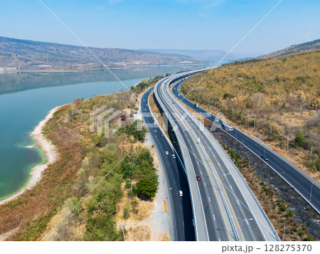 Drone shot aerial view landscape of the M6 motorway Expressway Nakhon Ratchasima Province - Bang Pa-in. Lam Ta Khong River and Mountain. Drone shot of scenic landscape rural place traffic. Nakhon Drone shot aerial view landscape of the M6 motorway Expressway Nakhon Ratchasima Province - Bang Pa-in. Lam Ta Khong River and Mountain. Drone shot of scenic landscape rural place traffic. Nakhon 128275370