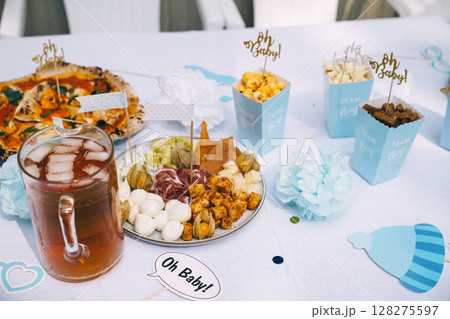 Celebration party table featuring snacks, drinks, and decor for a joyful gathering Celebration party table featuring snacks, drinks, and decor for a joyful gathering 128275597