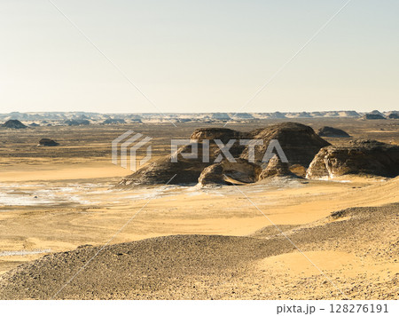 White rock formations and sand dunes in Egypt's White Desert, natural desert landscape 128276191