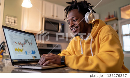 Male student attending a live-streamed data science webinar in a cozy, modern kitchen setting. Data scientist 128276287