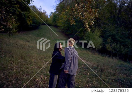 two 15-year-old teenagers in love play, hug , spend time together in an autumn park two 15-year-old teenagers in love play, hug , spend time together in an autumn park 128276526