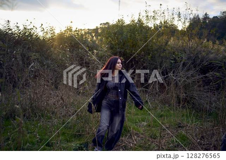 15-year-old teenage couple in love playing in  reeds at sunset 128276565