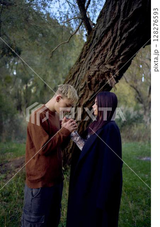 15-year-old teenage couple in love walks through the park on a cold autumn evening 15-year-old teenage couple in love walks through the park on a cold autumn evening 128276593