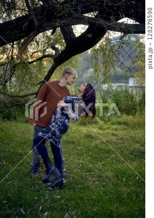 15-year-old teenage couple in love walks through the park on a cold autumn evening 15-year-old teenage couple in love walks through the park on a cold autumn evening 128276598