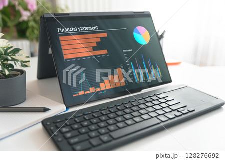 Laptop 2 in 1 with financial data sheet on screen Laptop 2 in 1 with financial data sheet on screen 128276692
